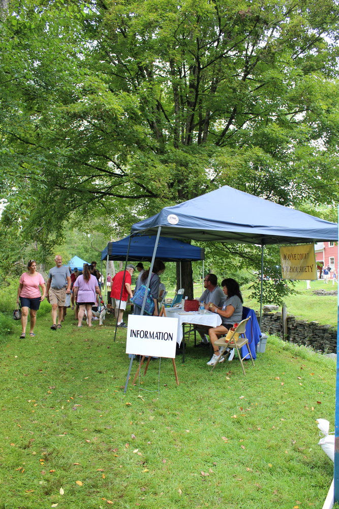 Visitors explore the information on offer at Canal Fest, sponsored by the Wayne County Historical Society.